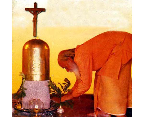 Fr. Peter Julia at a tabernacle shaped like the Shiva Linga